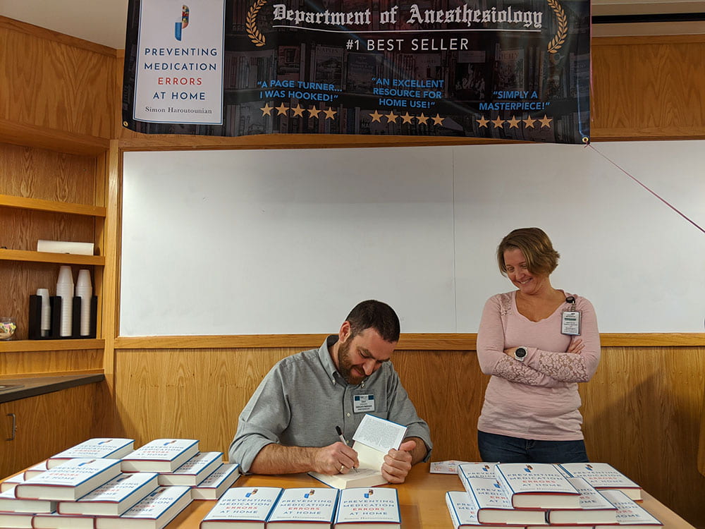 Dr. Haroutounian signing book